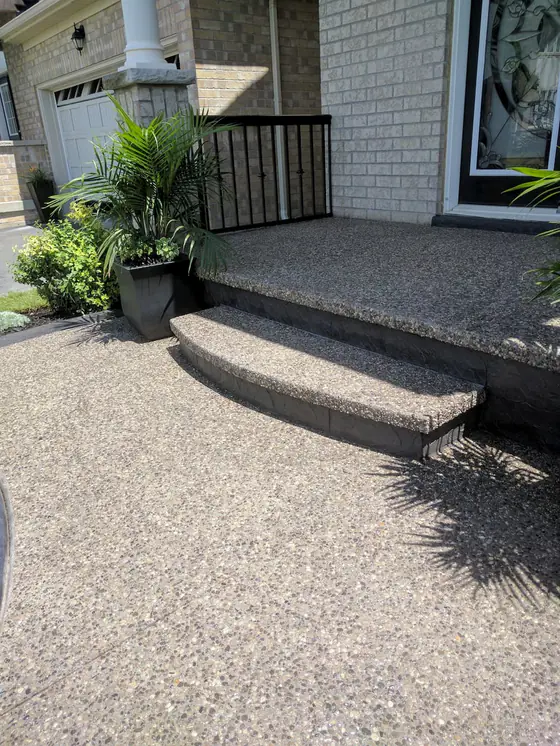 Exposed aggregate porch and wide curved front steps