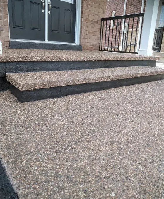 A close view of wide exposed aggregate entrance steps