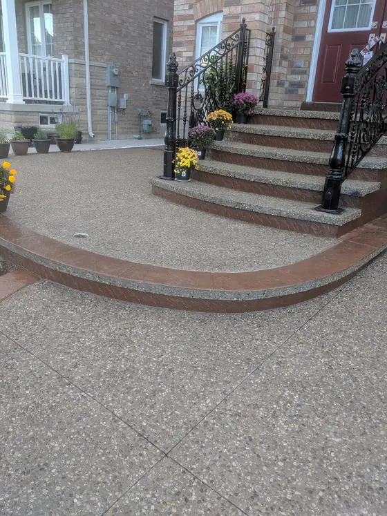 Aggregate driveway and curved steps with a red border