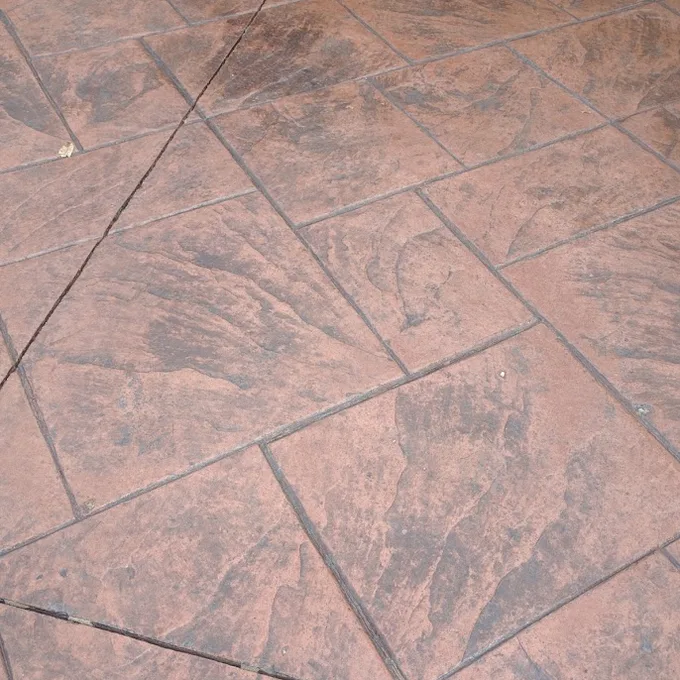 Terracotta stamped concrete after sealing, with renewed colour and defined stone texture